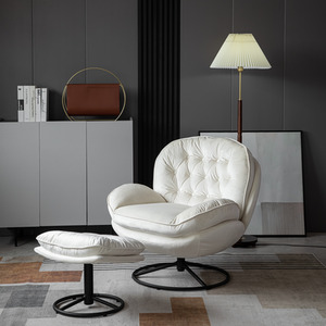 Beige velvet swivel chair with foot stool