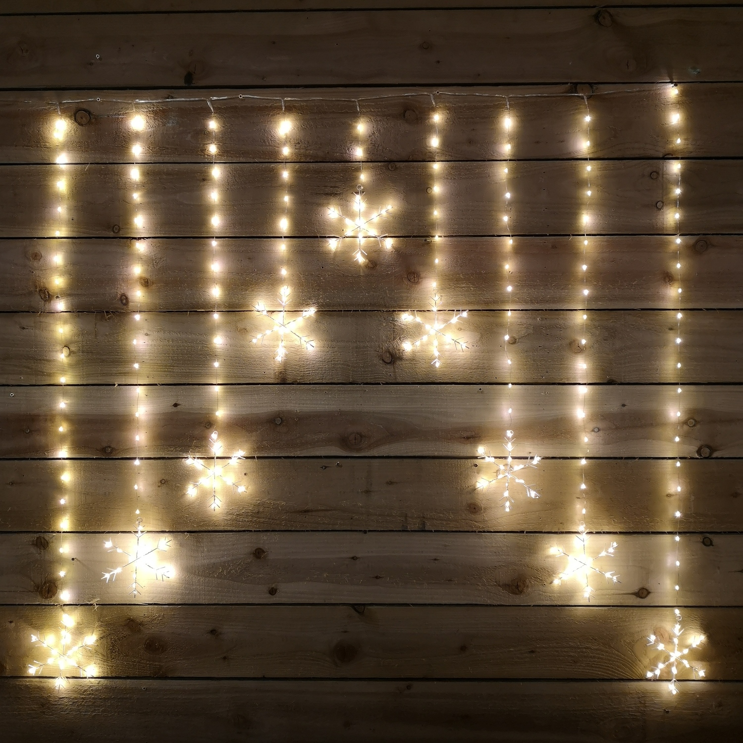 Samuel Alexander 1.2m x 1.2m Christmas Static Snowflake LED Silver Pin Wire V Curtain Lights in Warm White